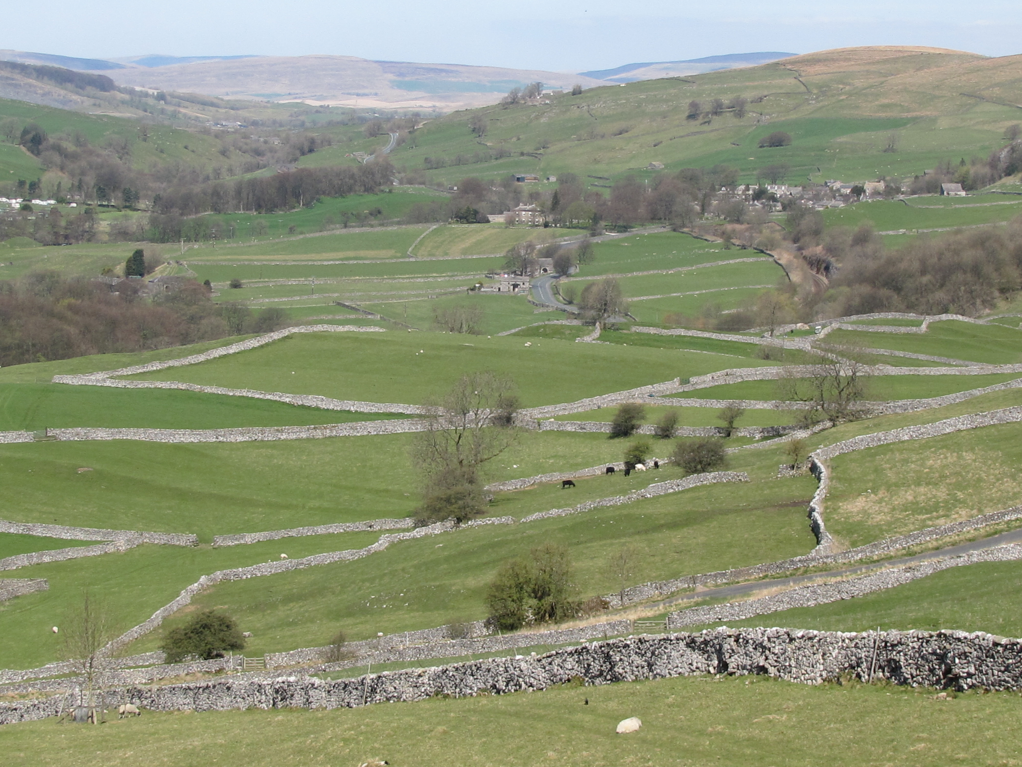 Photo of green fields and stone walls
